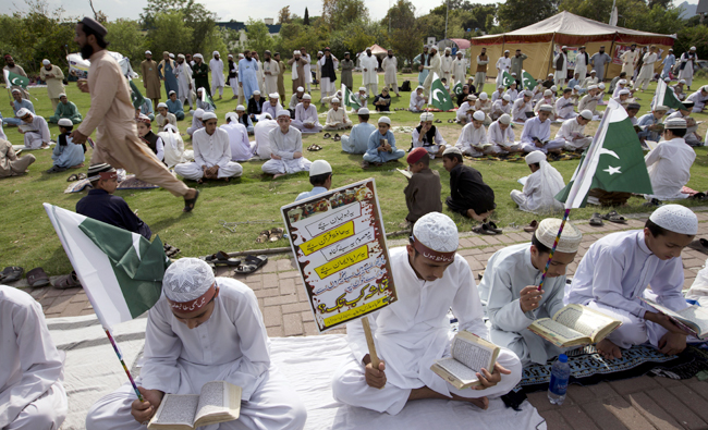 Pakistani religious students affiliated with various Islamic seminaries read Quran and pray for the victims of a deadly April 2, 2018 airstrike by Afghan forces in the Afghan province of Kunduz, in Islamabad, Pakistan on April 11, 2018. (AP)
