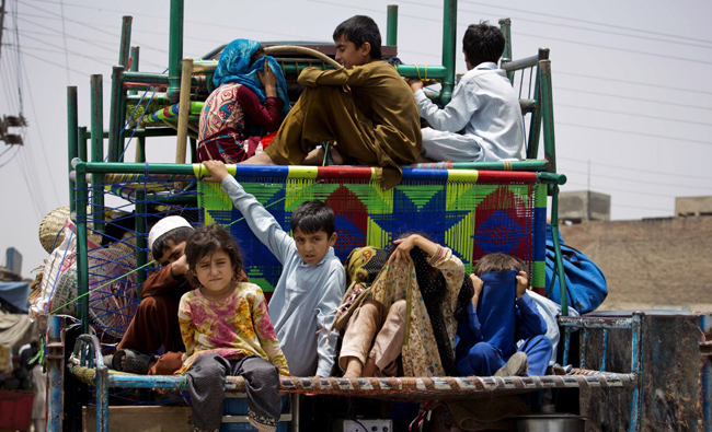 In this file photo, Families arrive in Bannu after fleeing their villages in the Pakistani tribal area of North Waziristan. (AP)