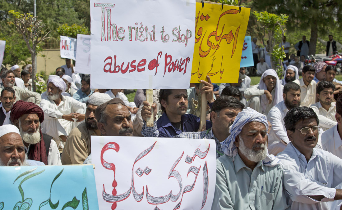 Family members of a young Pakistani man killed by a US diplomat in a road accident have rallied, asking the government to ensure that justice is done, in Islamabad, Pakistan, Friday, April 13, 2018. Placard at center on top reads, “Down with American murderer.” Sign in foreground reads — “For How Long? ” (AP)