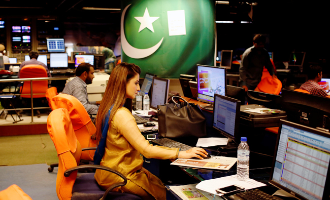 An employee works at the control room of the Geo News television channel in Karachi, Pakistan on April 11, 2018. (REUTERS)