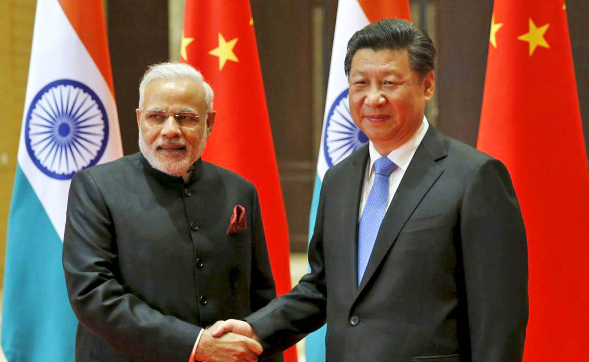 In this file photo, Indian Prime Minister Narendra Modi, left, and Chinese President Xi Jinping shake hands before they hold a meeting in Xian, Shaanxi province, China, May 14, 2015. (REUTERS)
