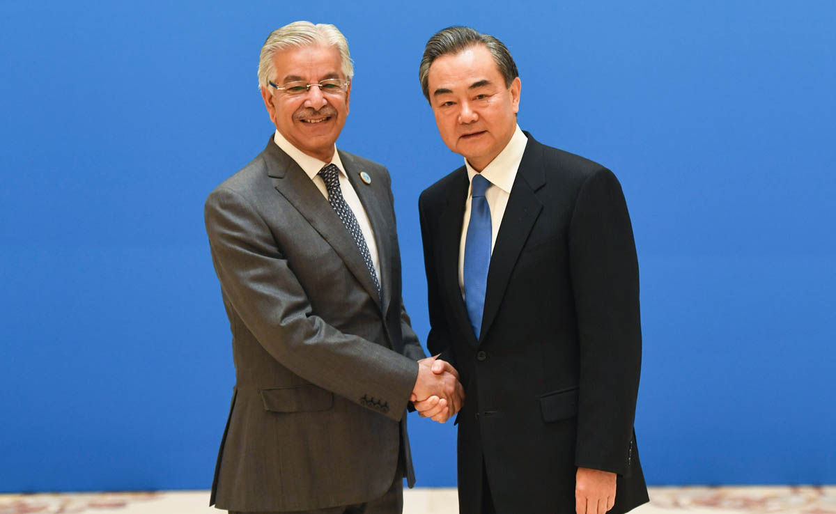 Pakistan’s Foreign Minister Khawaja Muhammad Asif, left, shakes hands with Chinese Foreign Minister Wang Yi before a meeting of foreign ministers and officials of the Shanghai Cooperation Organization (SCO) at the Diaoyutai State Guest House in Beijing on April 24, 2018. (AFP)