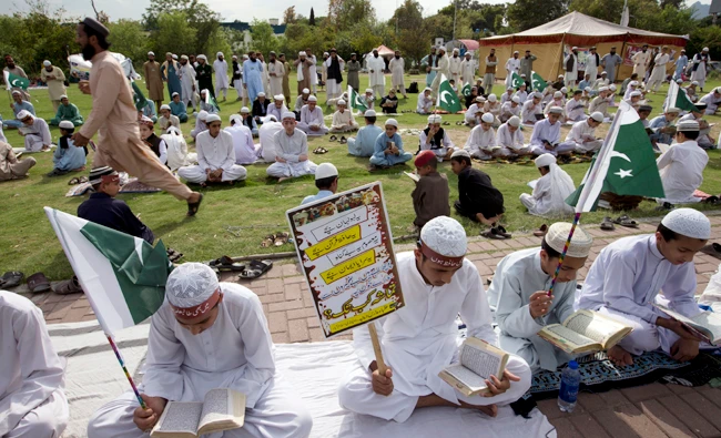 Pakistani religious students affiliated with various Islamic seminaries read Quran and pray for the victims of a deadly April 2, 2018 airstrike by Afghan forces in the Afghan province of Kunduz, in Islamabad, Pakistan on April 11, 2018. (AP)