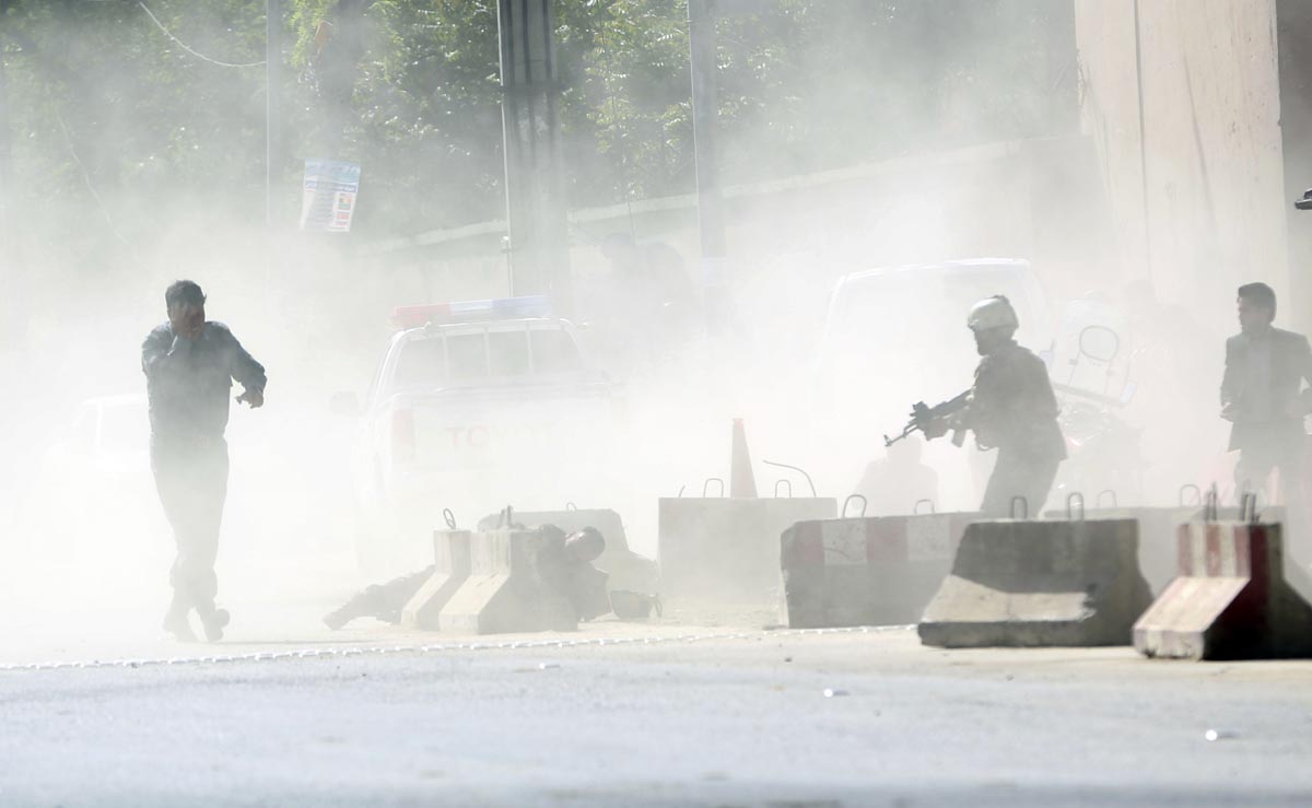 Security forces stand amid smoke at the site of a suicide attack after the second bombing in Kabul, Afghanistan, Monday, April 30, 2018. (AP)