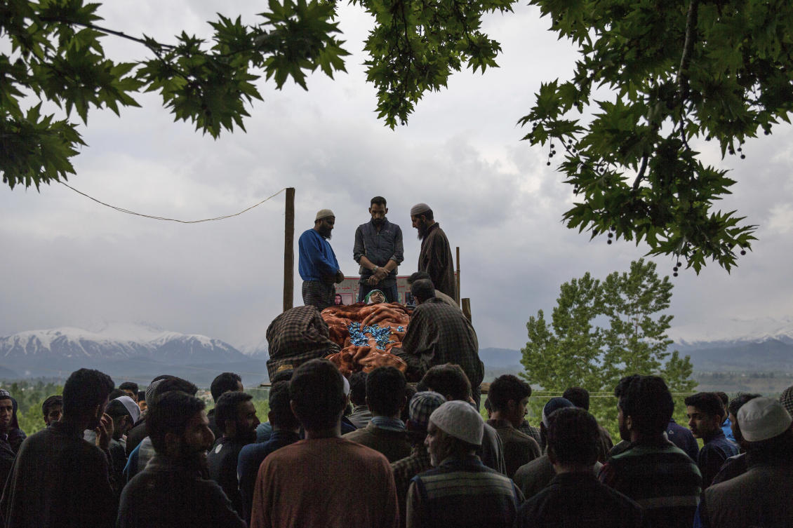 Kashmiri villagers attend the funeral of a young student Umar Abdullah Kumar at Pinjura village 52 kilometers (33 miles) south of Srinagar, Indian controlled Kashmir, Thursday, May 3, 2018. Umar was killed and dozens others wounded after Indian troops fired at rock-throwing protesters who helped the trapped rebels escape. (AP/Dar Yasin)