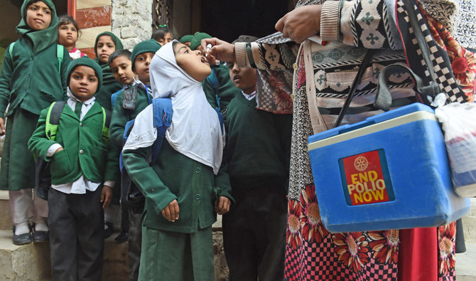 In this file photo, a Pakistani health worker administers polio vaccine drops to school children during a polio campaign in Lahore on Jan. 15, 2018. (AFP)