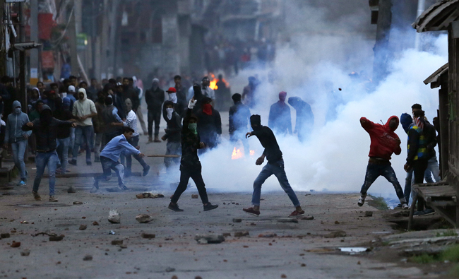 Kashmiri protesters throw stones on government forces during a protest in Srinagar, Indian controlled Kashmir on May 7, 2018. (AP)