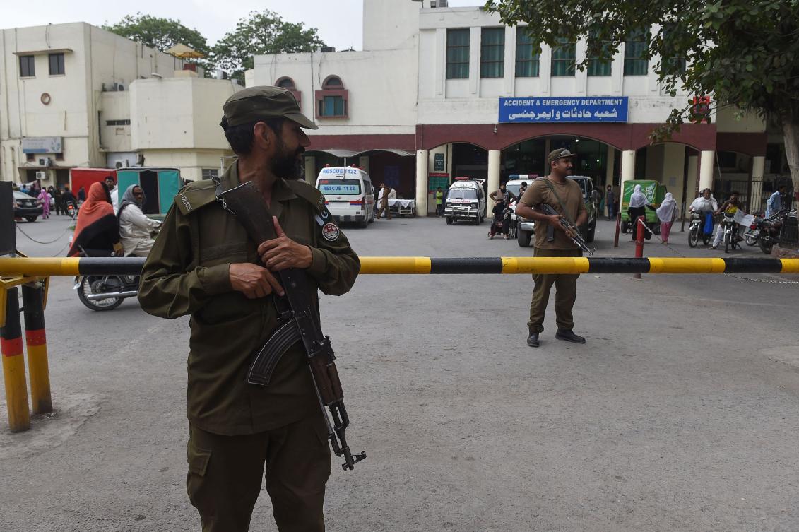 Pakistani policemen stand guard outside the hospital where country interior minister Ahsan Iqbal is recovering after an assassination attempt in Punjab late Sunday against him. (AFP)