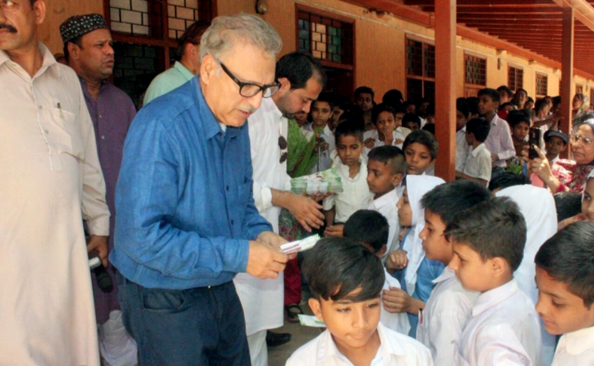 President of PTI’s Sindh chapter Dr. Arif Alvi distributing pencils with seeds to schoolchildren in Karachi. (Photo courtesy: Dr. Arif Alvi/Twitter)