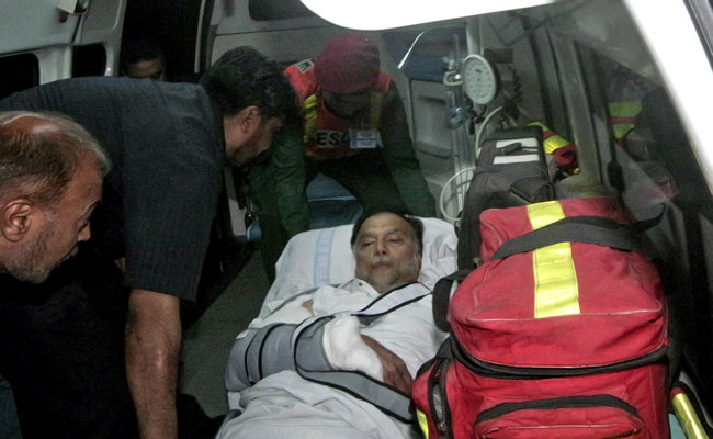 In this handout photo released on May 6, 2018, injured Pakistan's Interior Minister Ahsan Iqbal, center, is evacuated from a helicopter on their arrival in Lahore. (Photo courtesy: Press Information Department via AFP)
