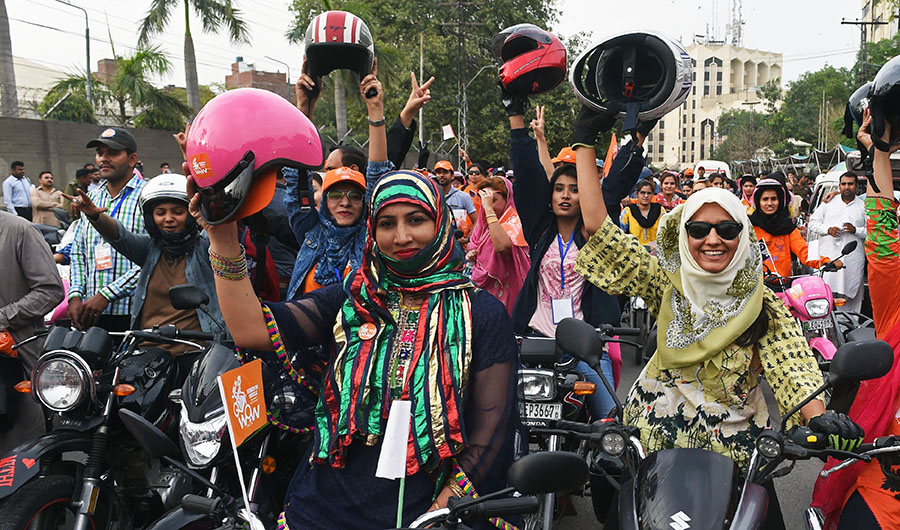 Pakistani women celebrate as they ride pink motorcycles during the pink motorcycles rally in Lahore on May 13, 2018. (AFP)