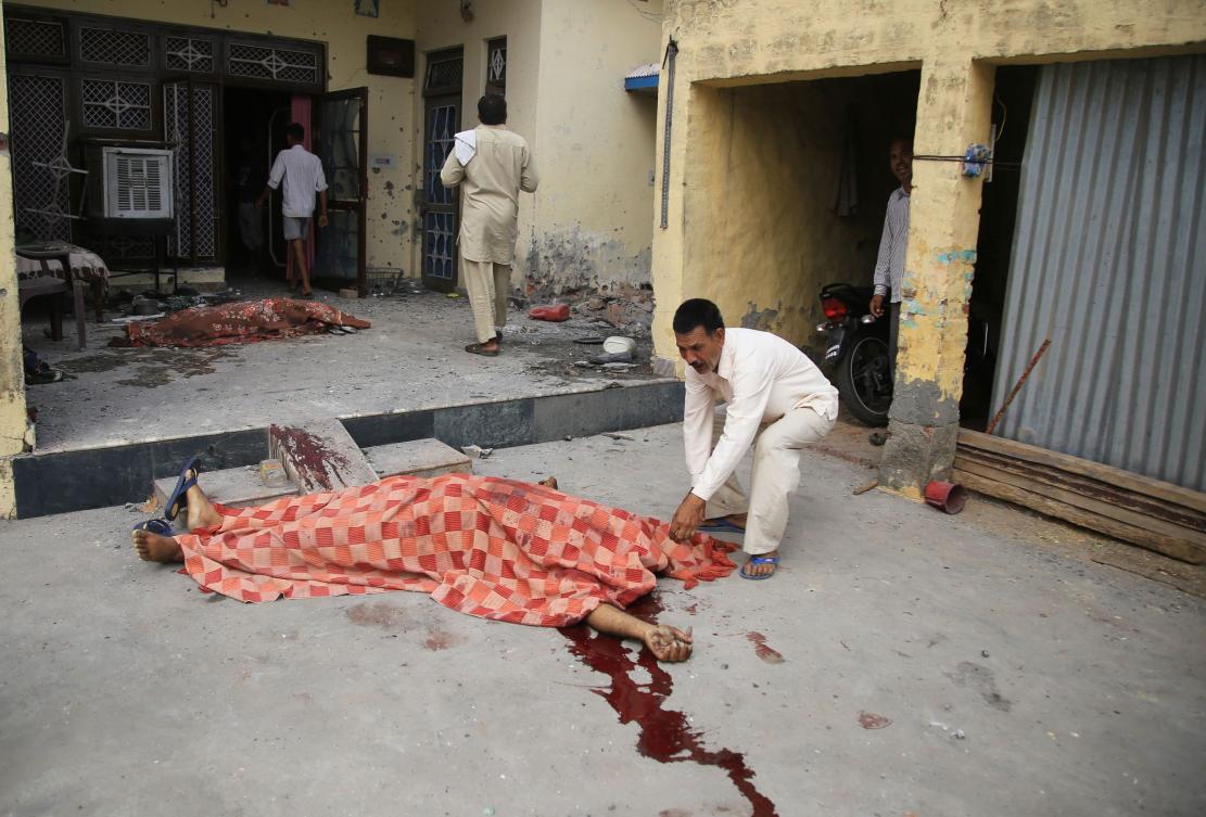 The bodies of Tersem Lal and his wife Manjeet Kour, who were killed during cross-border firing between India and Pakistan, lay on the ground in their house at Chanduchak village in Ranbir Singh Pura sector. (AFP)