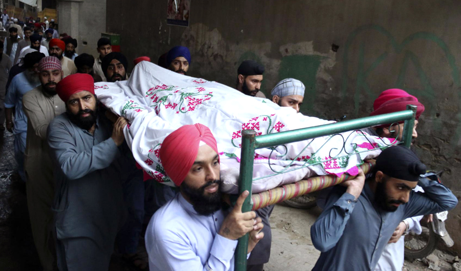 People attend the funeral of Charanjit Singh who was a well-known member of the country's minority Sikh community and an outspoken critic of the Taliban, in Peshawar, Pakistan on May 29, 2018. (AP)