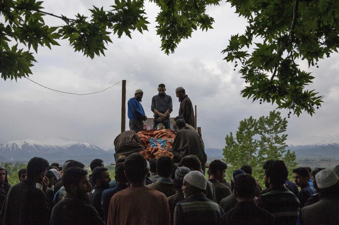 Kashmiri villagers attend the funeral of a young student Umar Abdullah Kumar at Pinjura village 52 kilometers (33 miles) south of Srinagar, Indian controlled Kashmir, Thursday, May 3, 2018. Umar was killed and dozens others wounded after Indian troops fired at rock-throwing protesters who helped the trapped rebels escape. (AP/Dar Yasin)