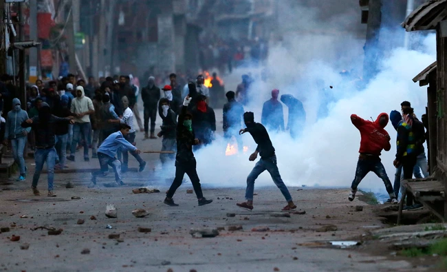 Kashmiri protesters throw stones on government forces during a protest in Srinagar, Indian controlled Kashmir on May 7, 2018. (AP)