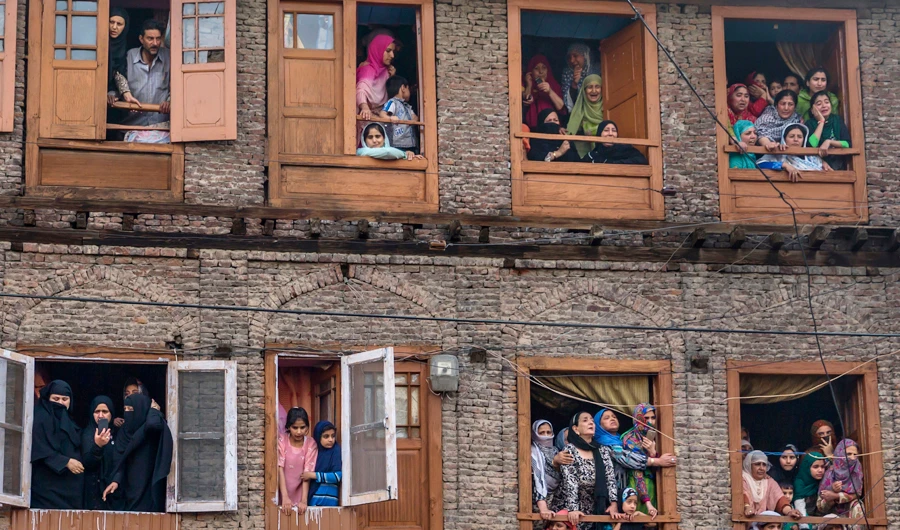 Kashmiri Muslims grieve as they watch the funeral procession of a local rebel Fayaz Ahmad Hamal, in Srinagar, Indian controlled Kashmir, Saturday, May 5, 2018. (AP)