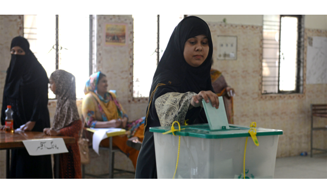 In this file photo, Pakistani voter casts her ballot in a by-election in Lahore on Sept. 17, 2017. (AFP)