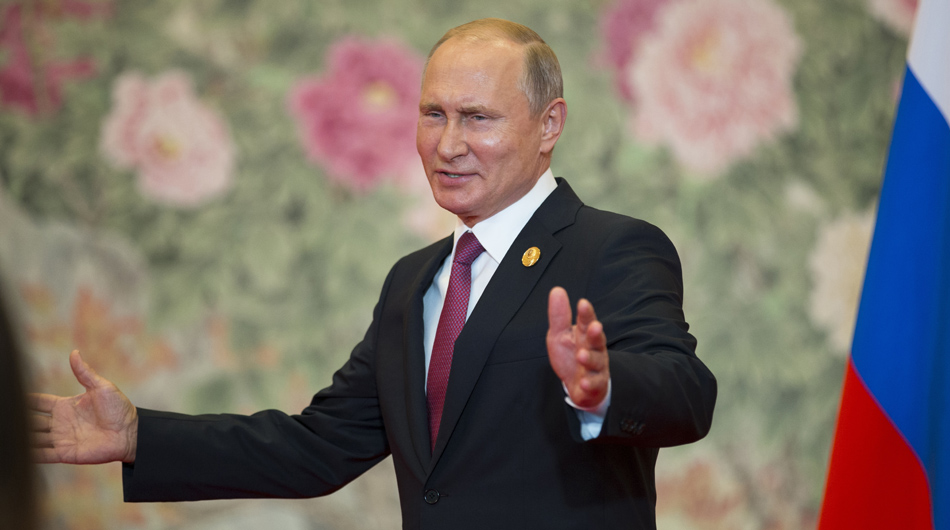 Russian President Vladimir Putin listens a reporter's question during his news conference after the Shanghai Cooperation Organization (SCO) Summit in Qingdao in eastern China's Shandong Province on June 10, 2018. (AP Photo/Alexander Zemlianichenko)