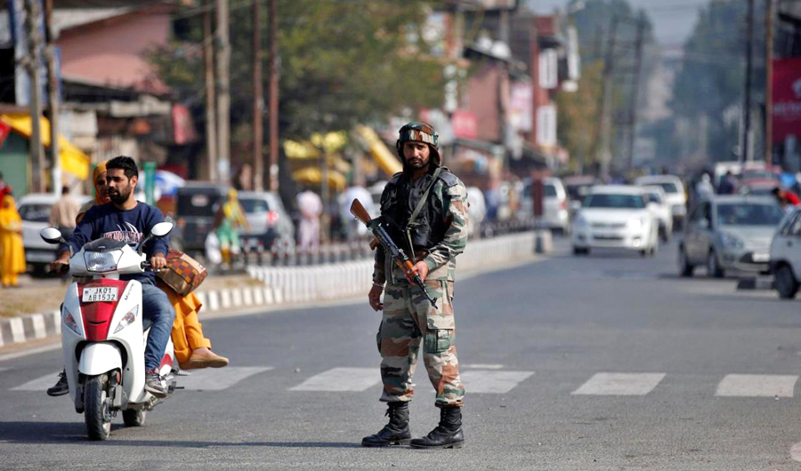 In this file photo, An Indian army soldier stands guard on a road on the outskirts of Srinagar. (REUTERS)