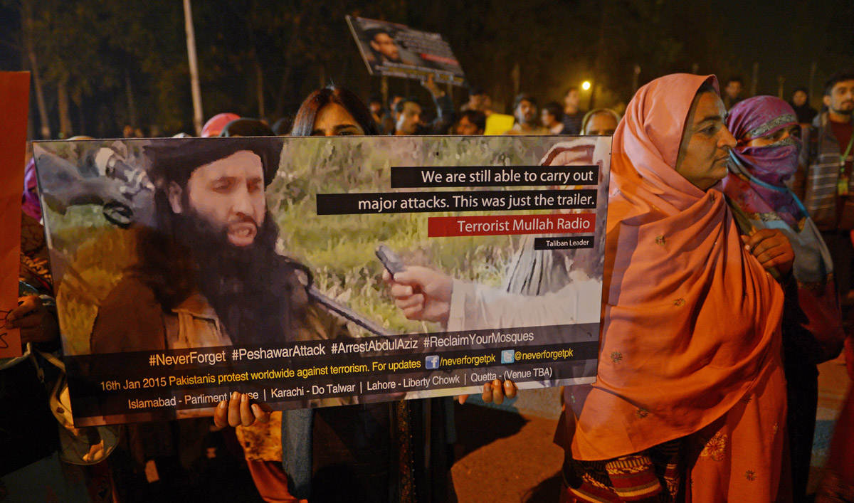 In this file photo, a Pakistani civil society activist holds a placard bearing the image of Tehreek-e-Taliban Pakistan (TTP) leader Maulana Fazlullah during a protest in Islamabad on Jan. 16, 2015. (Farooq Naeem/AFP)