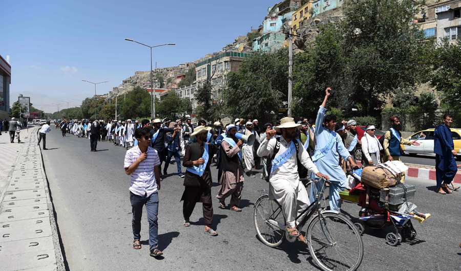 Afghan peace activists march in demand to an end to the war from Helmand as they arrive in Kabul on June 18, 2018. Dozens of peace protesters arrived in Kabul on June 18 after walking hundreds of kilometres across war-battered Afghanistan, as the Taliban ended an unprecedented ceasefire and resumed attacks in parts of the country. (AFP)