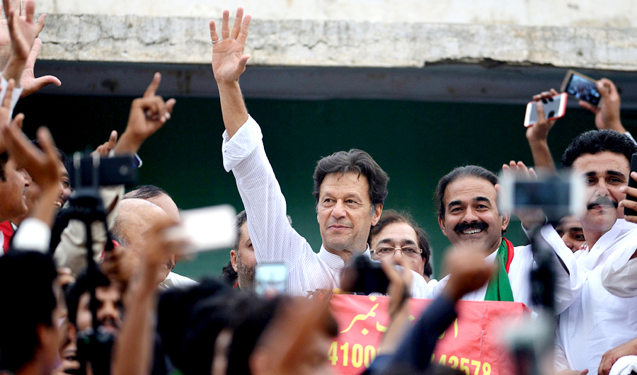 Imran Khan (C), Pakistani cricketer-turned-opposition leader and head of the Pakistan Tehreek-i-Insaf (PTI) delivers a speech during an election campaign in Mianwali, some 240 kms southwest of Islamabad, on June 24, 2018. (AFP)