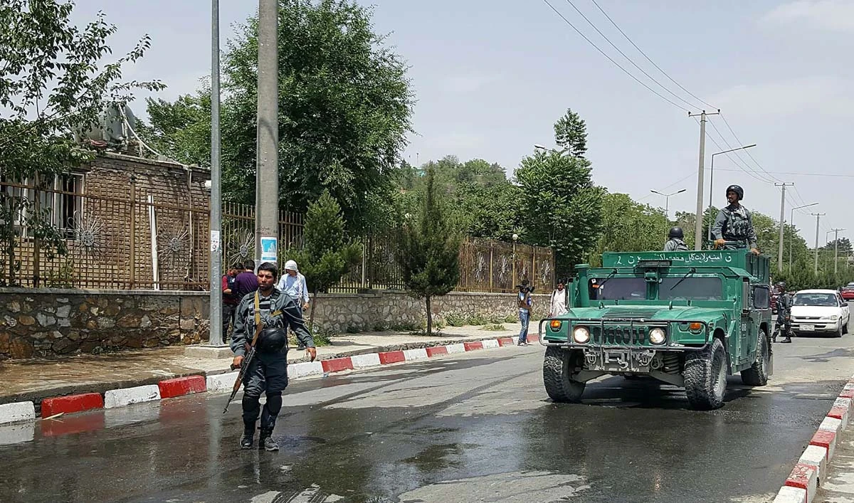 Afghan policemen stand guard near the site of a suicide attack at the gates of Kabul’s Polytechnic University in Kabul on June 4, 2018. (AFP)