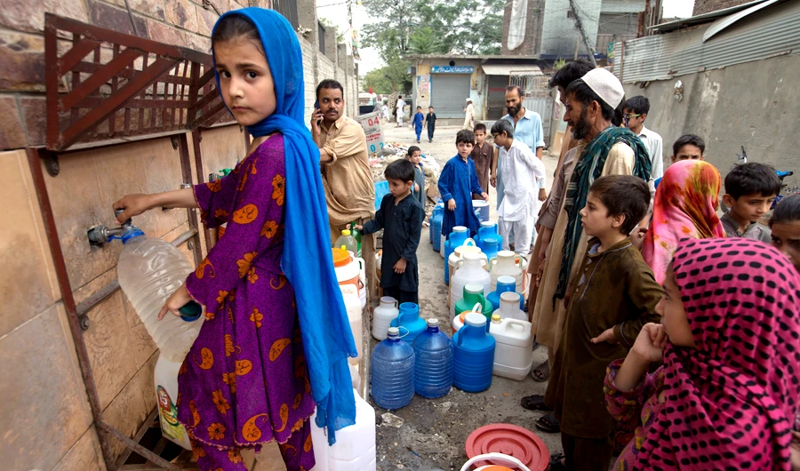 People wait for their turn to fill containers with clean water in Rawalpindi, Pakistan, on June 5, 2018. Pakistanis are facing a shortage of clean drinking water due to the low level of water in the country's dams caused by the hot summer and a lack of rainfall. (AP)