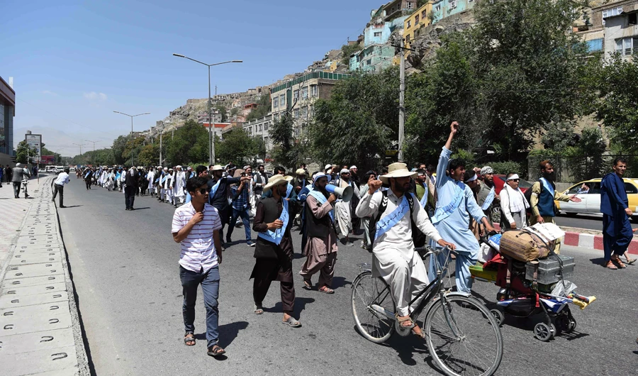 Afghan peace activists march in demand to an end to the war from Helmand as they arrive in Kabul on June 18, 2018. Dozens of peace protesters arrived in Kabul on June 18 after walking hundreds of kilometres across war-battered Afghanistan, as the Taliban ended an unprecedented ceasefire and resumed attacks in parts of the country. (AFP)