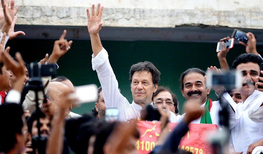 Imran Khan (C), Pakistani cricketer-turned-opposition leader and head of the Pakistan Tehreek-i-Insaf (PTI) delivers a speech during an election campaign in Mianwali, some 240 kms southwest of Islamabad, on June 24, 2018. (AFP)