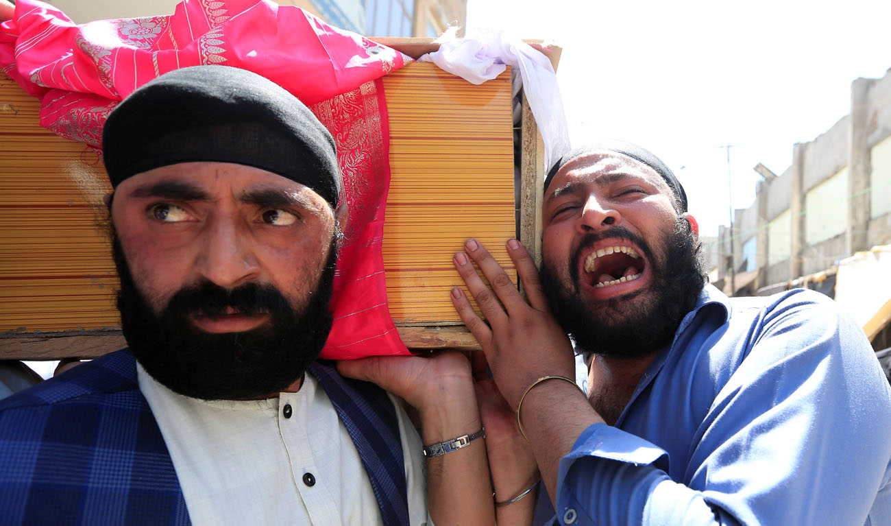 Afghan Sikh men carry the coffin of one of the victims of yesterday’s blast in Jalalabad city, Afghanistan July 2, 2018. (PARWIZ/REUTERS)