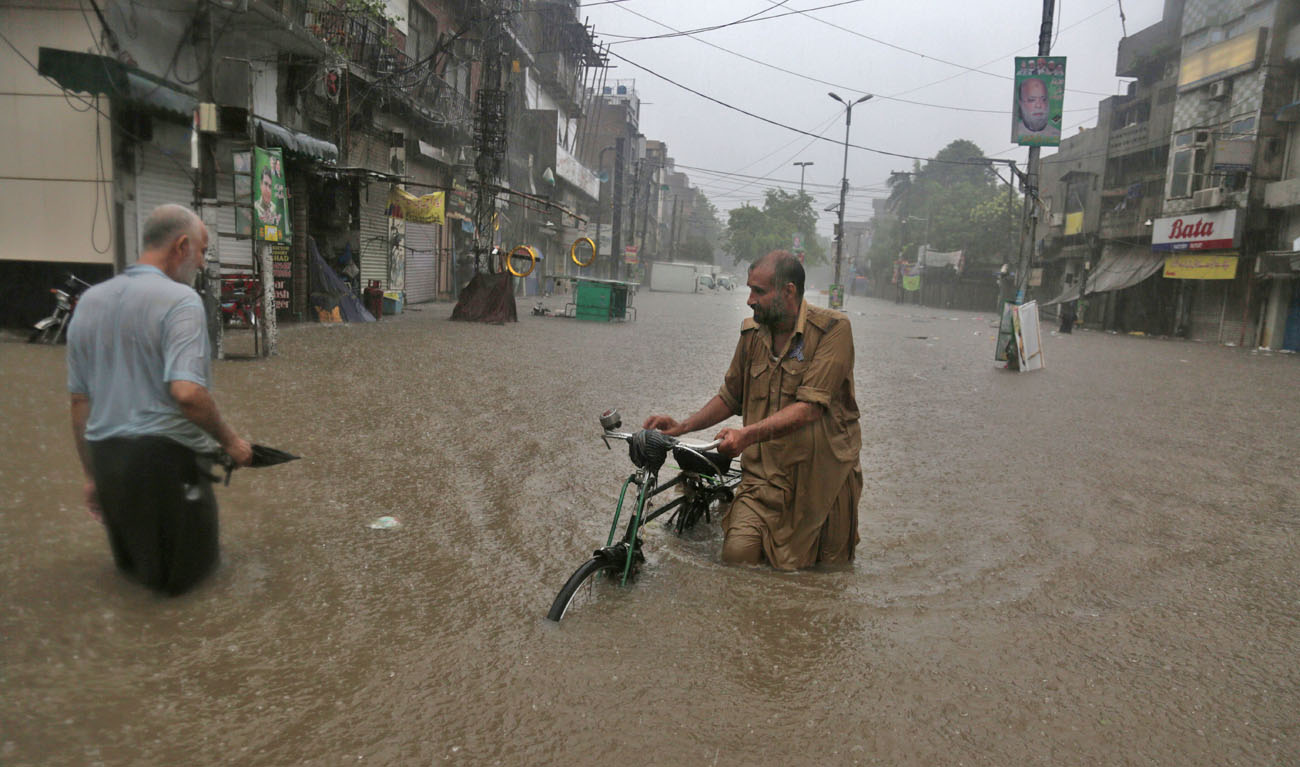 Torrential monsoon rains lashed many cities and towns across Pakistan before dawn Tuesday, flooding streets and killing six people, as authorities struggled to restore normalcy in rain-affected areas. (K.M. CHAUDARY/AP)