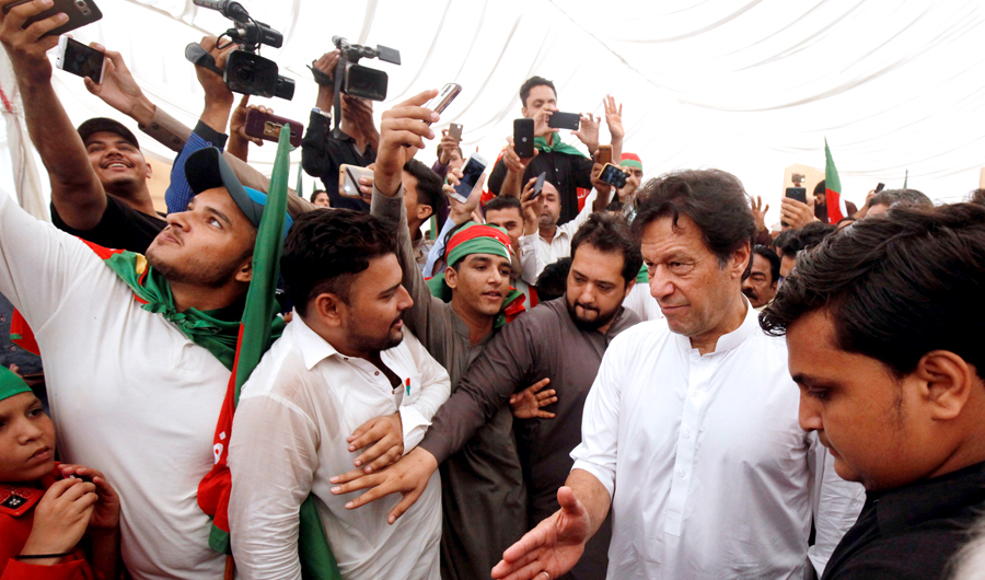 Imran Khan (2nd R), chairman of the Pakistan Tehreek-e-Insaf (PTI) political party, gestures to clear the way among supporters during a campaign meeting ahead of general elections in Karachi, Pakistan, on July 4, 2018. (REUTERS)