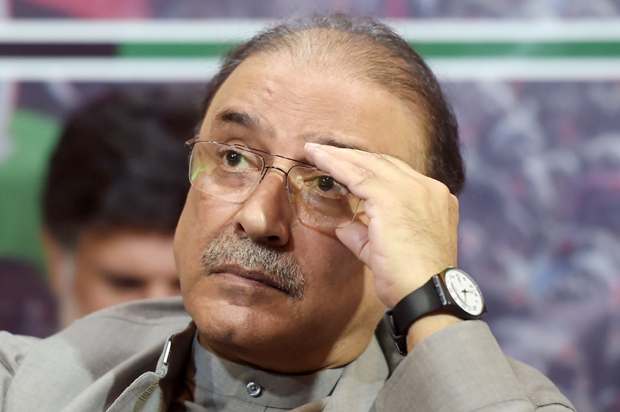 Former Pakistani president Asif Ali Zardari listens to his son and chairman of the Pakistan Peoples Party (PPP) Bilawal Bhutto Zardari (unseen) during the party manifesto presentation for the forthcoming general election during a press conference in Islamabad on June 28, 2018. (AFP)