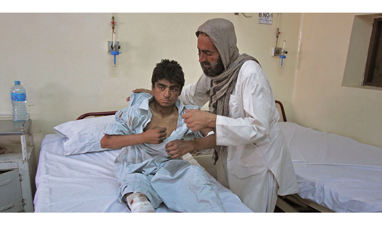 A youth injured in Friday’s blast is cared for by a relative at a hospital in Quetta. (AFP)