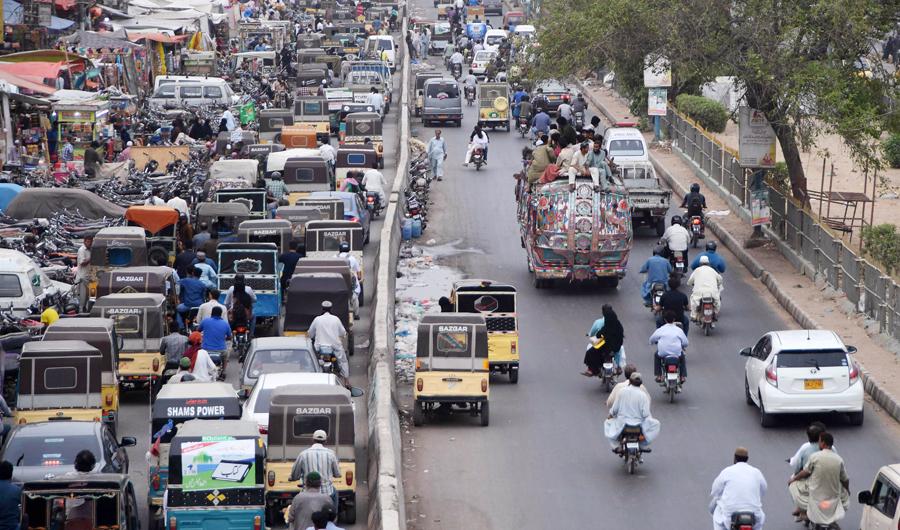 This photo taken on July 17, 2018 shows Pakistani commuters driving along a street in Karachi. Conservative Pakistan, with its limited family planning, has one of the highest birth rates in Asia at around three children per woman, according to the World Bank and government figures. That has led to a fivefold increase of the population since 1960, now touching 207 million, draft results from last year's census show. (AFP/ASIF HASSAN)