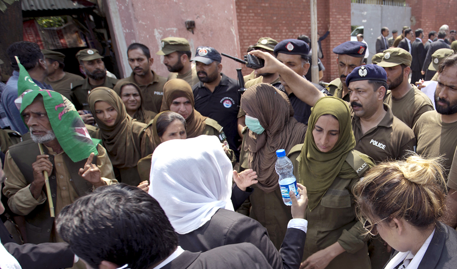 Police officers hold back supporters of Pakistan's jailed ex-Prime Minister Nawaz Sharif as they gather outside the Adiala jail where he is being held, in Rawalpindi, Pakistan, on July 19, 2018. (AP)