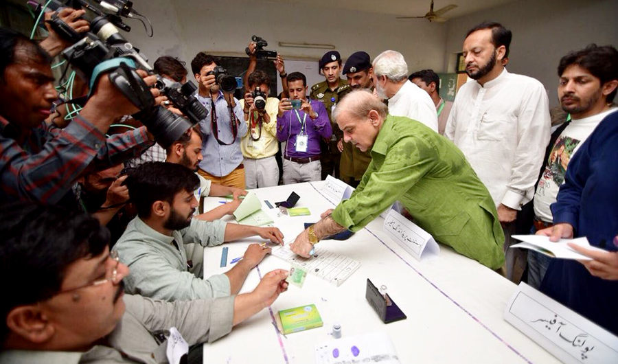 Former Punjab Chief Minister, Shahbaz Shrif, is fixing his thumb impression on the ballot paper book. (Photo courtesy: PML-N media cell)