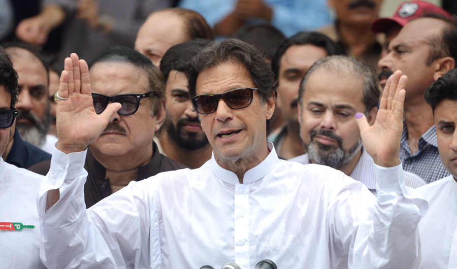 Pakistan's cricketer-turned politician Imran Khan of the Pakistan Tehreek-e-Insaf (Movement for Justice) speaks to the media after casting his vote at a polling station during the general election in Islamabad on July 25, 2018. (AFP)