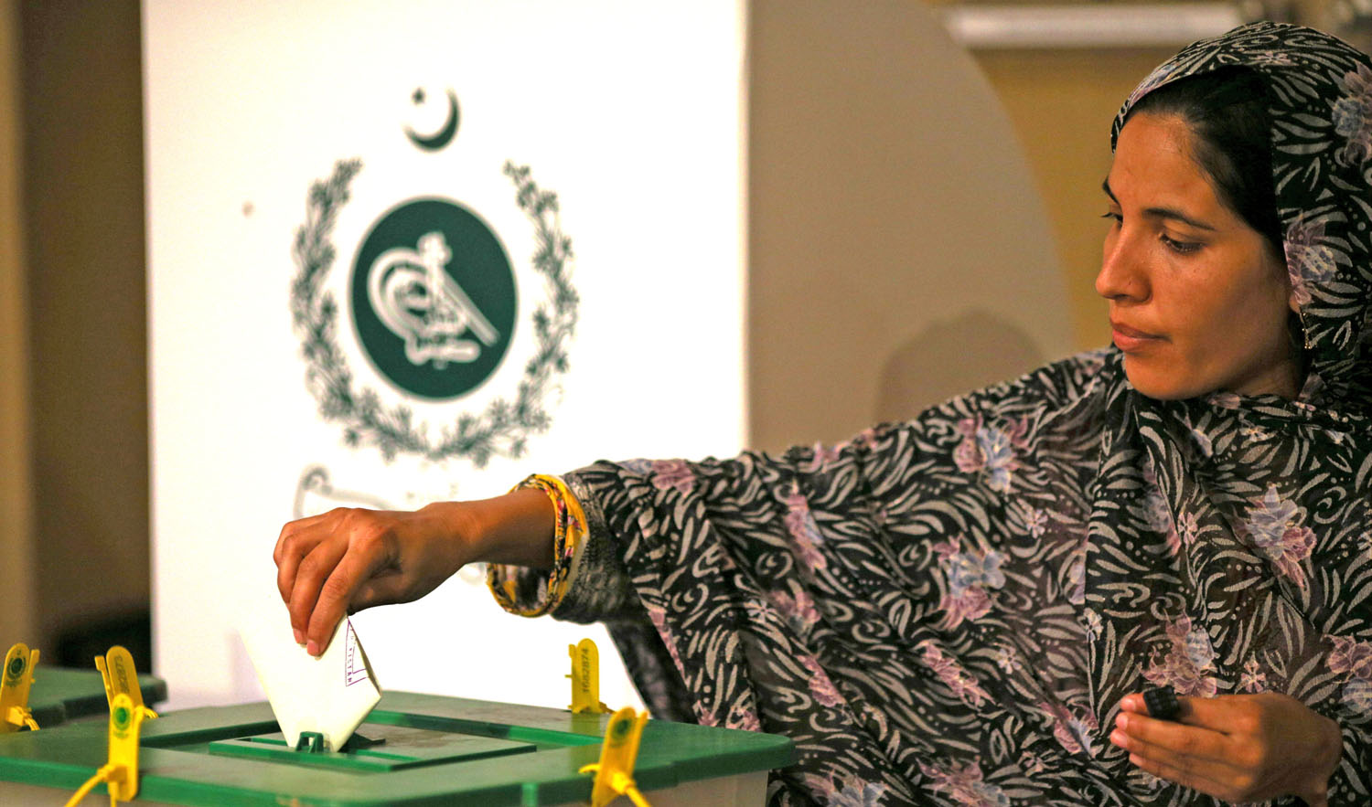 In this file photo, a voter casts her vote at a polling station during the general election in Islamabad, Pakistan, July 25, 2018. (ATHIT PERAWONGMETHA/REUTERS)
