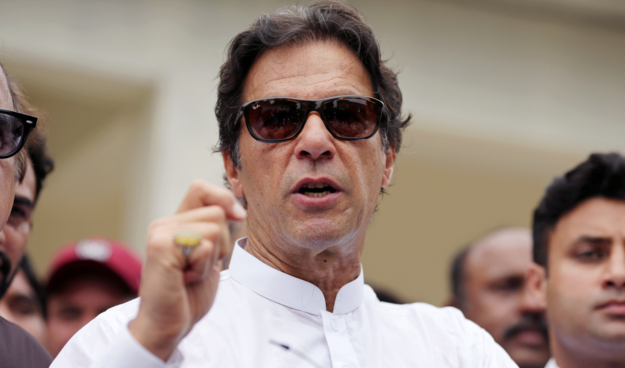 Cricket star-turned-politician Imran Khan, chairman of Pakistan Tehreek-e-Insaf (PTI), speaks to members of media after casting his vote at a polling station during the general election in Islamabad, Pakistan, on July 25, 2018. (REUTERS)