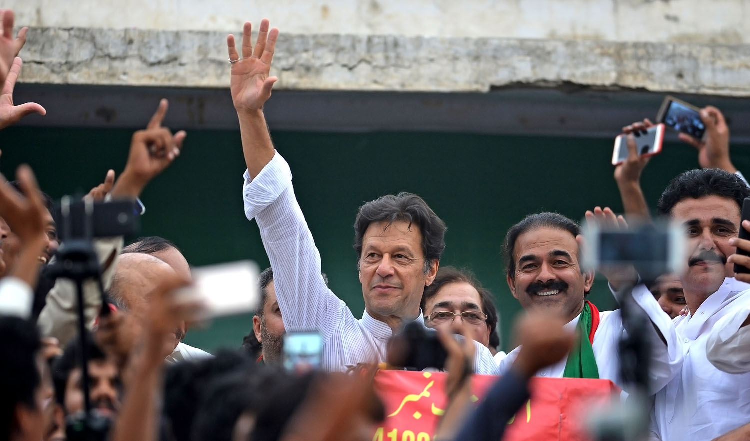 In this file photo, Imran Khan, center, Pakistani cricketer-turned-opposition leader and head of the Pakistan Tehreek-i-Insaf (PTI) delivers a speech during an election campaign in Mianwali, some 240 kms southwest of Islamabad, on June 24, 2018. (AAMIR QURESHI/AFP)