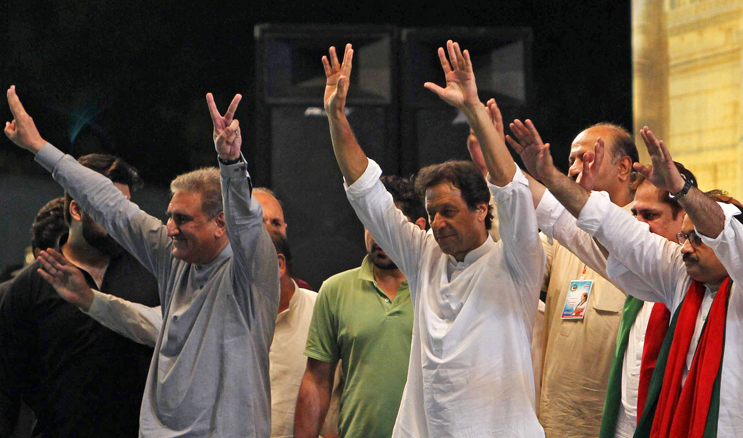 Pakistani cricket star-turned-politician and head of the party Pakistan Tehreek-e-Insaf (PTI) Imran Khan, center, greets supporters during a political campaign rally ahead of the general election in Multan on July 20, 2018. (SS MIRZA/AFP)