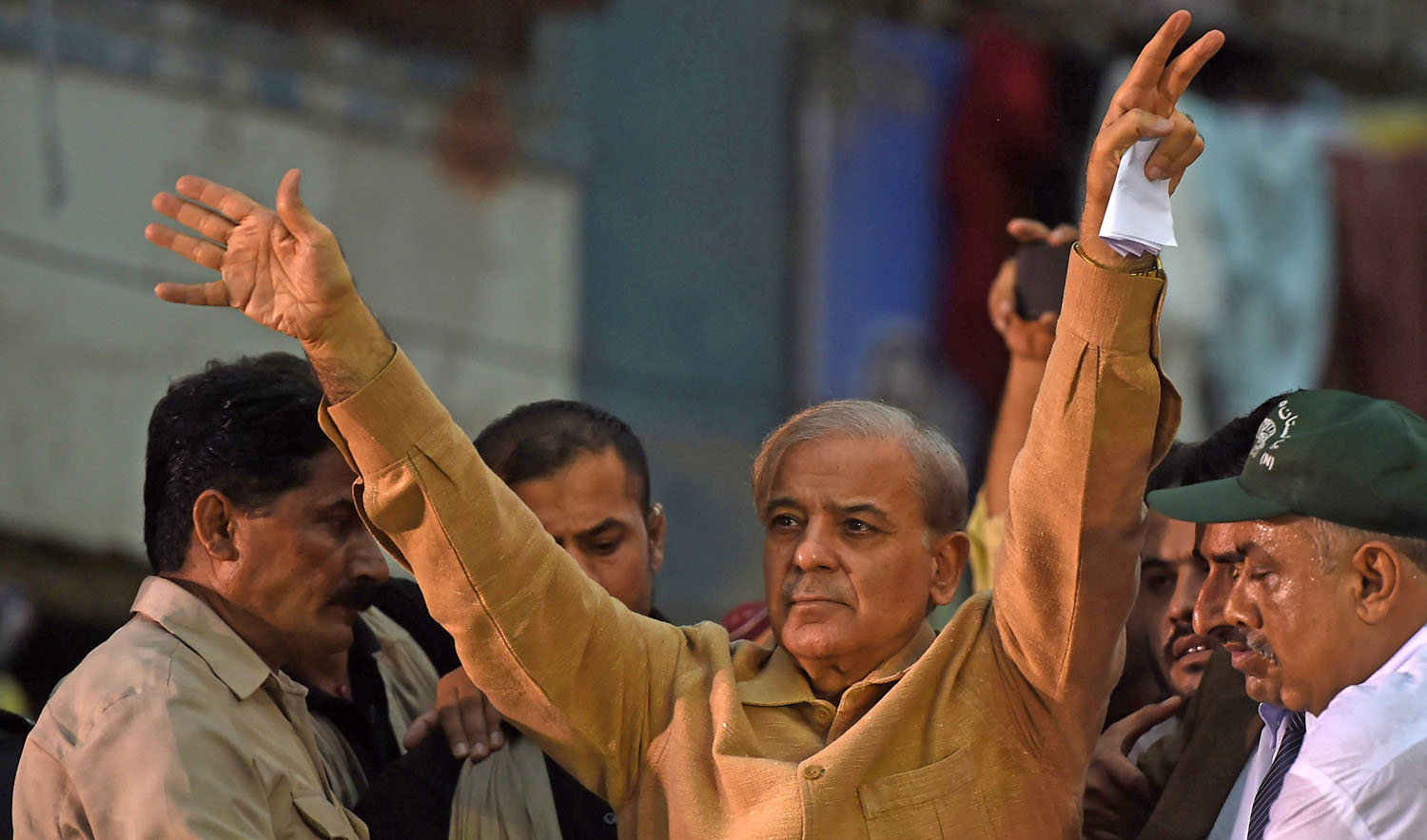 In this file photo, Shahbaz Sharif, center, the younger brother of ousted Pakistani prime minister Nawaz Sharif and the head of Pakistan Muslim League -Nawaz (PML-N), waves to supporters during an election campaign meeting in Karachi on June 26, 2018. (ASIF HASSAN/AFP)