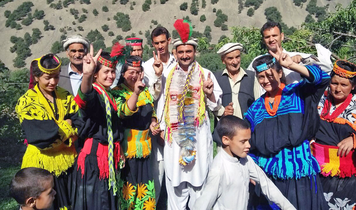 Wazir Zada poses with his community members as they celebrate his nomination for KP Assembly in Kalash valley of Chitral district. (Photo courtesy: Wazir Zada)