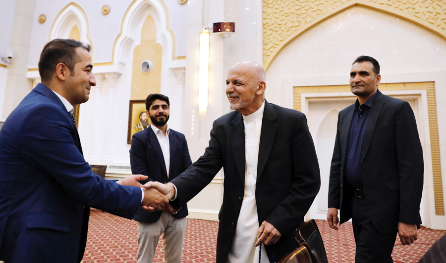In this file photo, Afghan President Ashraf Ghani shakes hands with media before a news conference in Kabul, Afghanistan. (REUTERS)