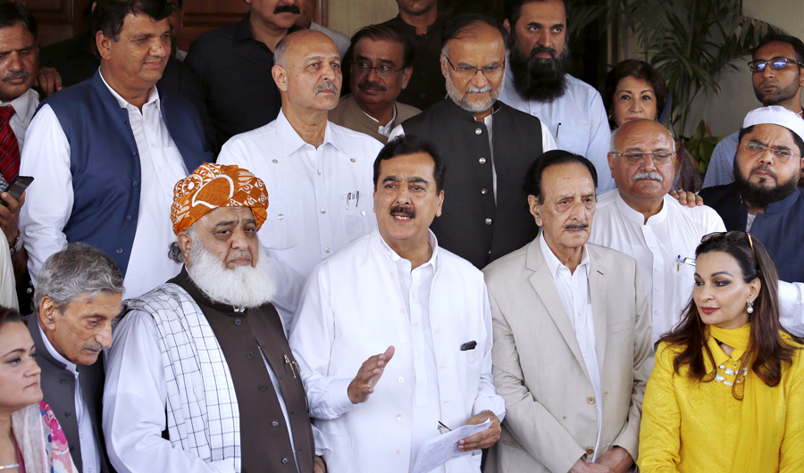 Former Prime Minister Yousuf Raza Gilani, front center, a leader in the Pakistan People's Party, and other Pakistani politicians speak to journalists after their meeting in Islamabad, Pakistan, on July 30, 2018. (AP)