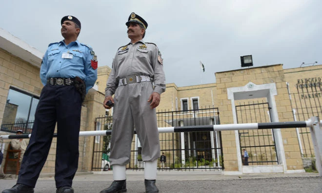 In this file photo, Pakistani policemen stand in front of the Election Commission of Pakistan (ECP) office in Islamabad. (FAROOQ NAEEM/AFP)