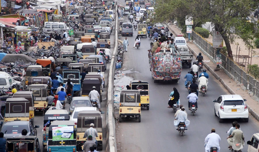 This photo taken on July 17, 2018 shows Pakistani commuters driving along a street in Karachi. Conservative Pakistan, with its limited family planning, has one of the highest birth rates in Asia at around three children per woman, according to the World Bank and government figures. That has led to a fivefold increase of the population since 1960, now touching 207 million, draft results from last year's census show. (AFP/ASIF HASSAN)
