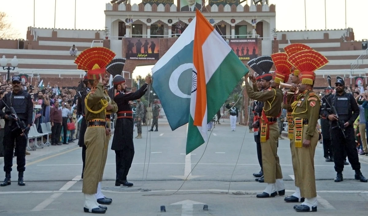 In this file photo, Pakistani Rangers (REAR) and Indian Border Security Force (BSF) personnel fold their respective national flags as they perform during the daily beating of the retreat ceremony on the India-Pakistan Border at Wagah on Feb. 20, 2017. (NARINDER NANU/AFP)